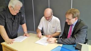 Photo: Dr Thomas Schirrmacher signing the constitution beside the notary (standing Manfred Kohl) Â© ReForma/van Rensburg